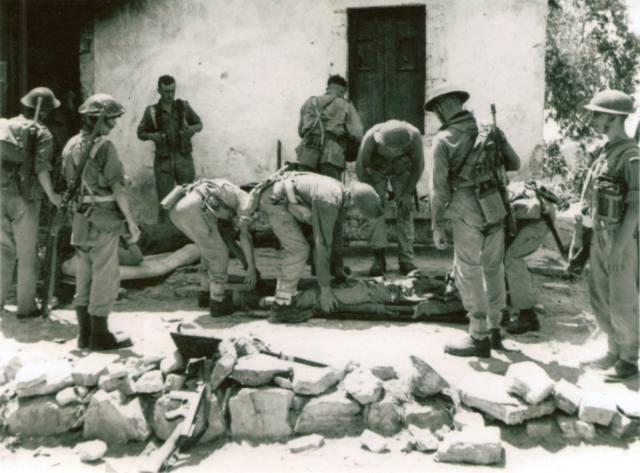 No.2 Commando tend to wounded during Operation Healing 2 at Spilje, Albania, 29 July 1944.